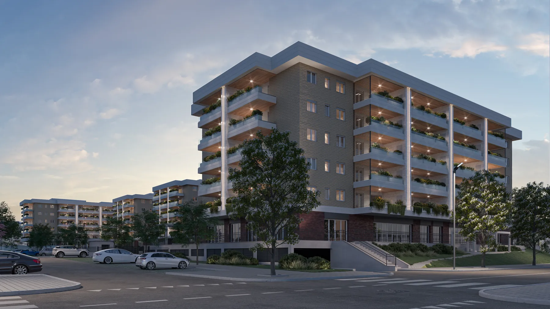 Un edificio di Urban District al tramonto, con i balconi illuminati e il verde intorno