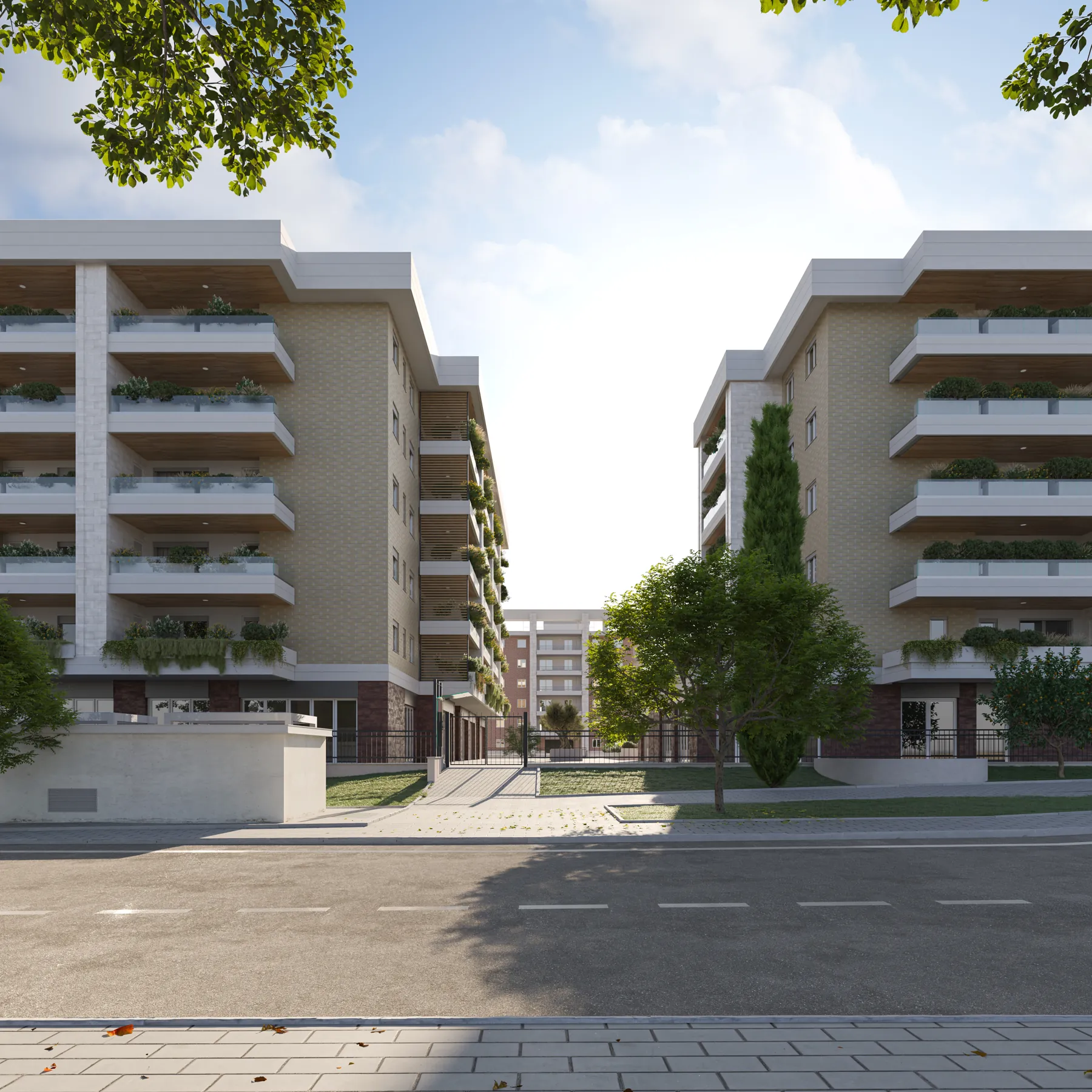 Il viale d’ingresso di Città Verde fra due edifici, con gli alberi in primo piano